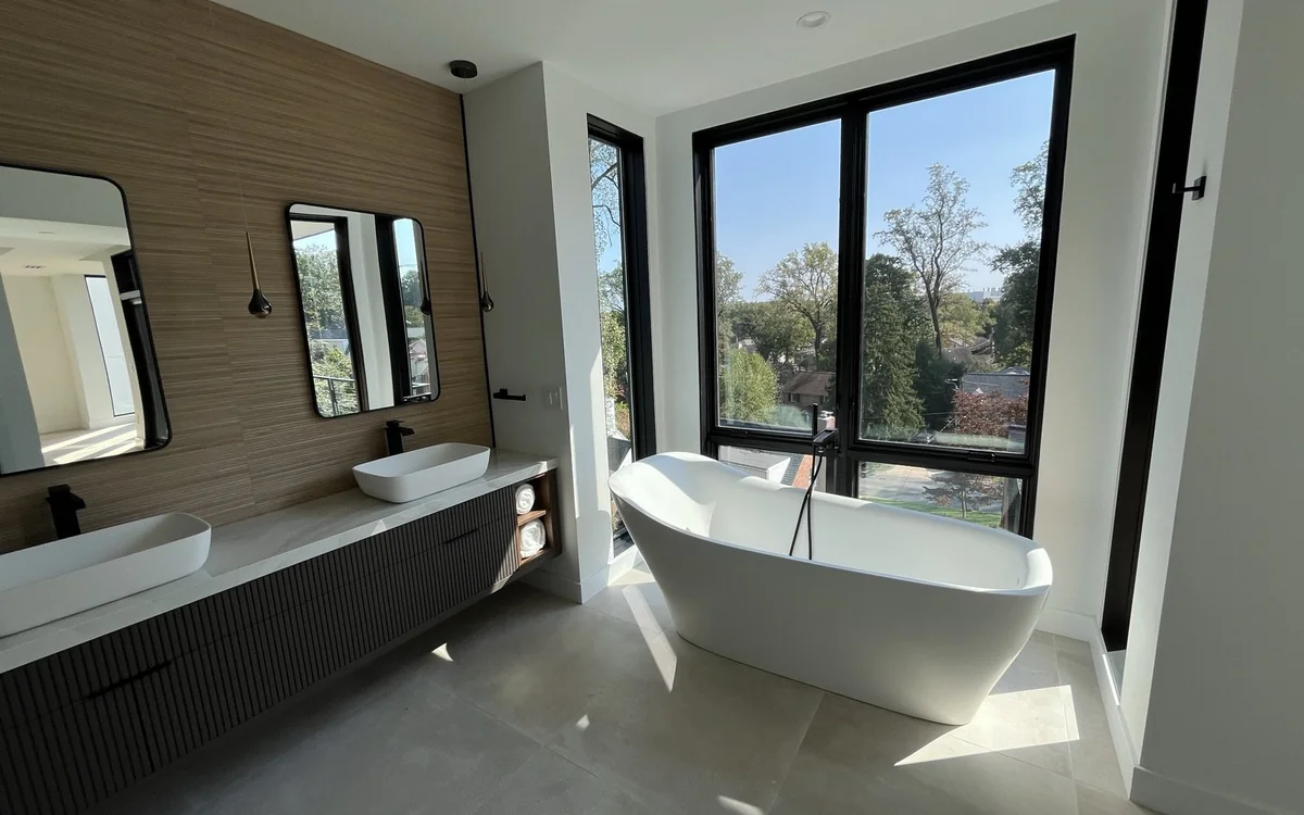 Accessible primary bathroom renovation with a walk-in shower, freestanding tub, and abundant natural light