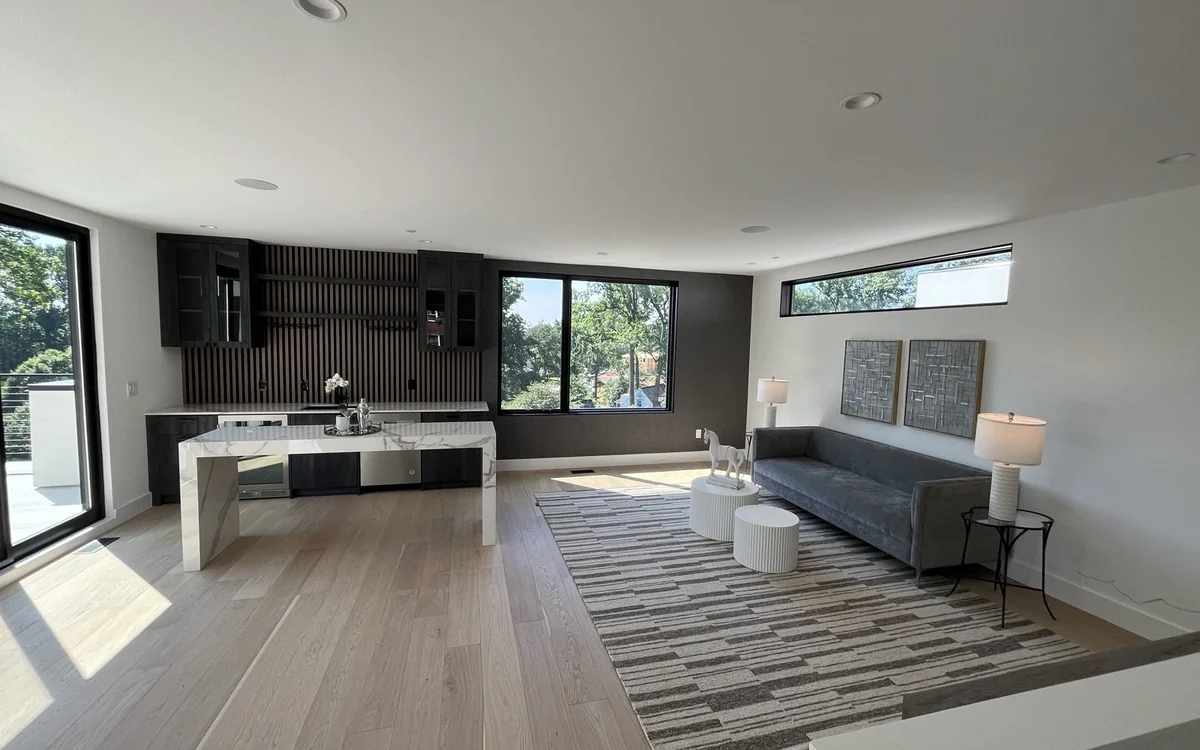 Finished open-plan lower level with a kitchen, lounge, recessed lighting, and durable wood-look flooring