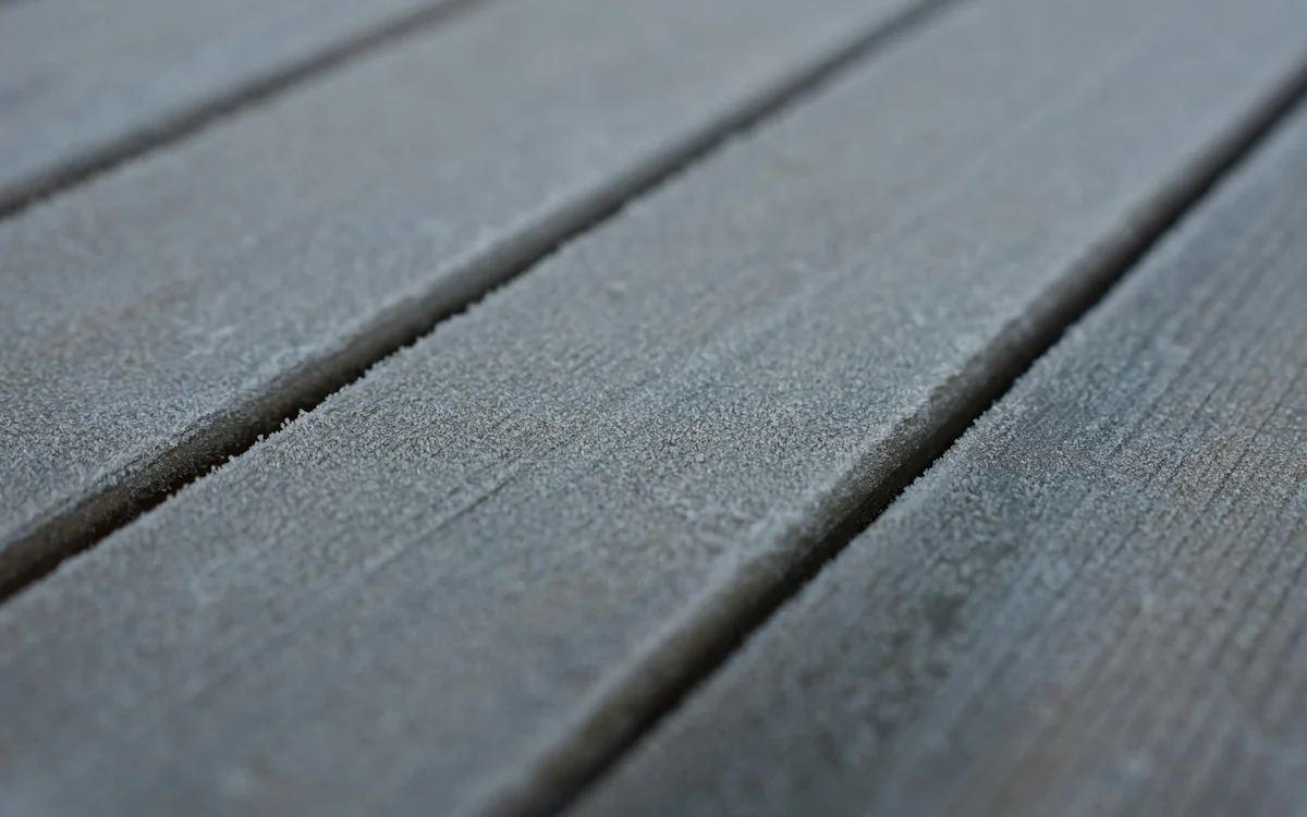 Close-up of weather-exposed deck boards showing texture, spacing, and surface performance