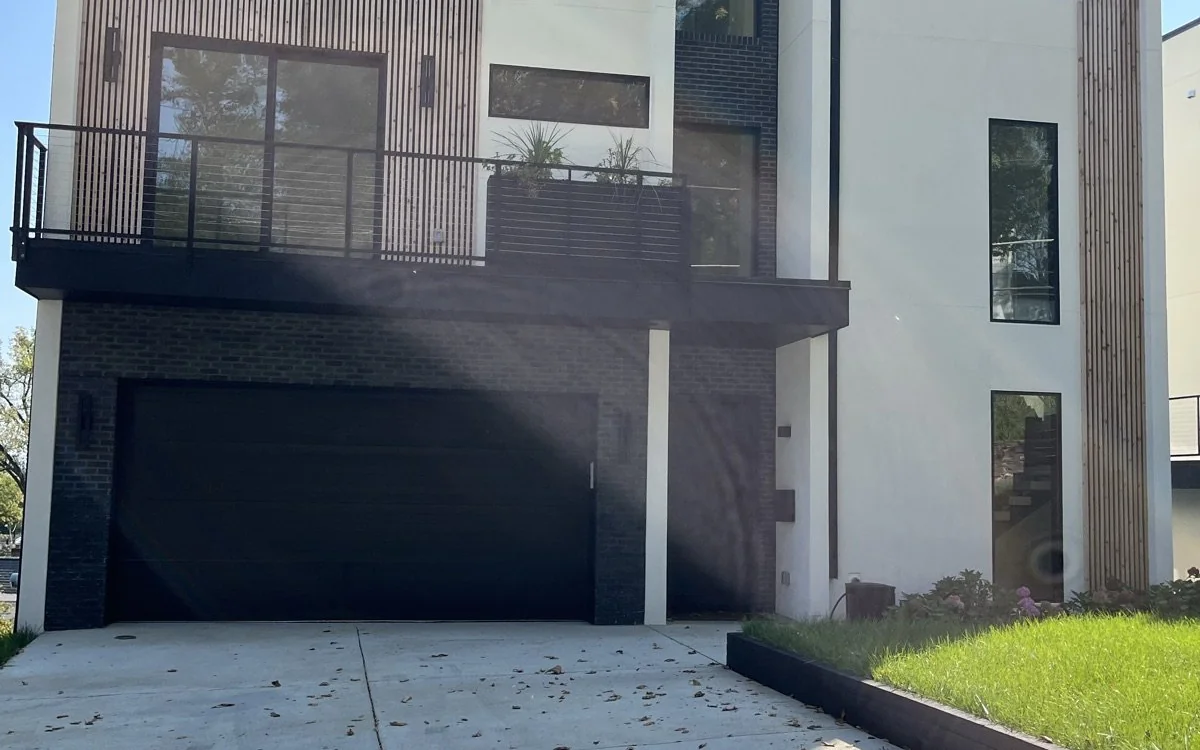 Modern attached garage and upper-level living space prepared for a residential conversion project
