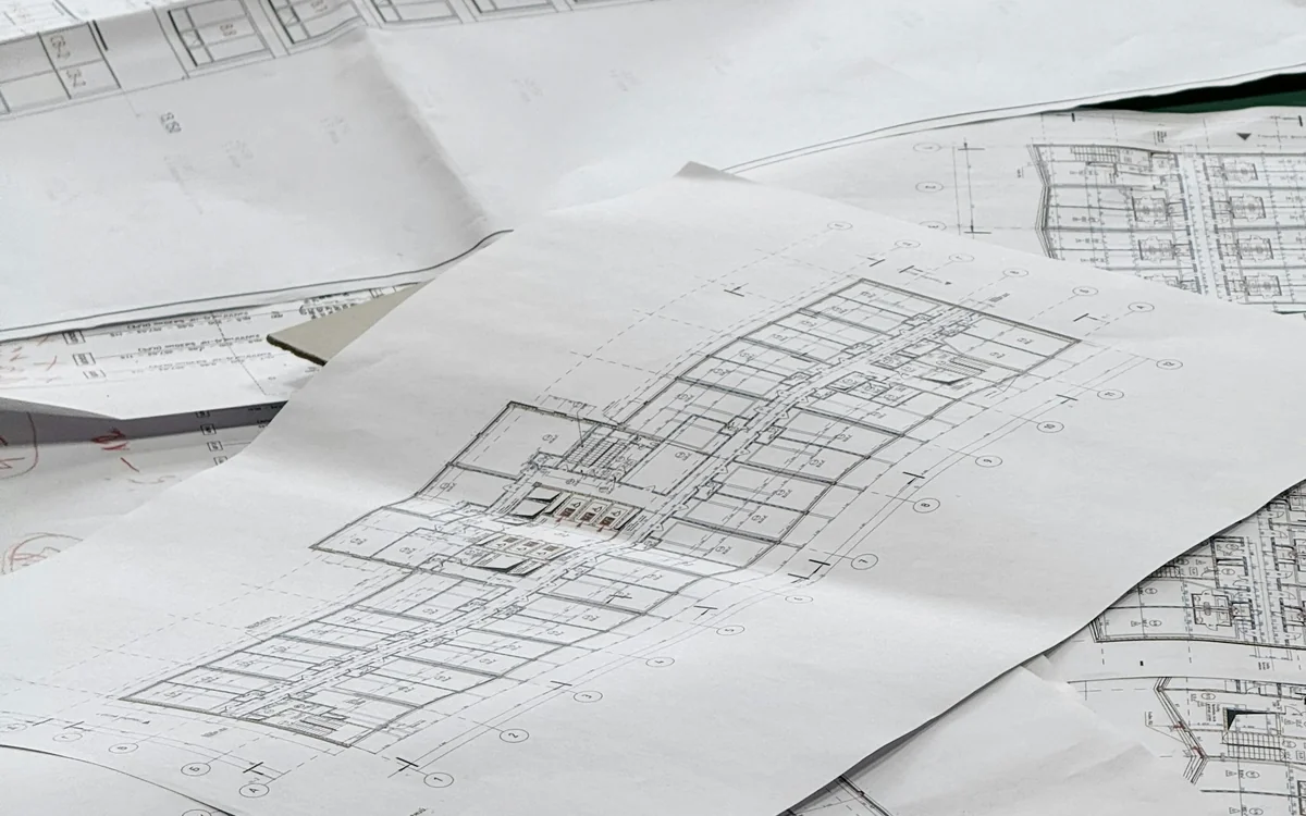 Residential blueprints and construction documents arranged for renovation scheduling