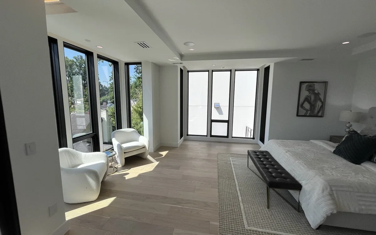 Freshly painted living room with warm white walls, painted trim, and natural light in a Maryland home
