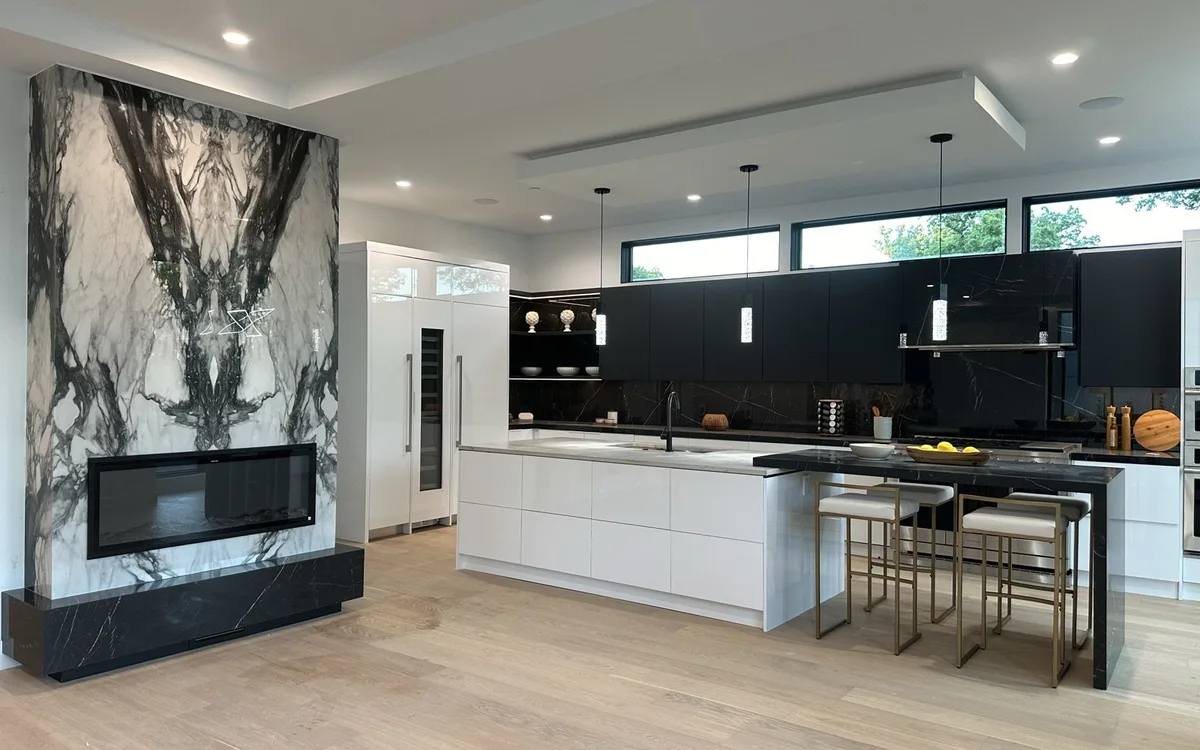Renovated laundry room with white upper cabinets, countertop over front-load washer and dryer, and utility sink in a Maryland home