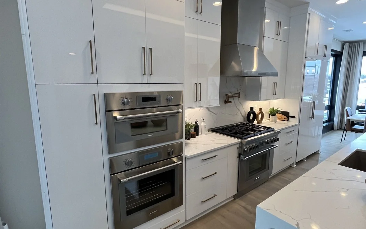 Renovated kitchen with layered recessed, pendant, and under-cabinet lighting