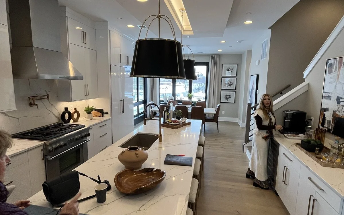 Bethesda-style kitchen remodel with custom white cabinets, marble island, and integrated lighting