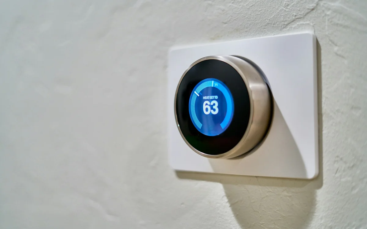 Smart thermostat installed on an interior wall for efficient home climate control