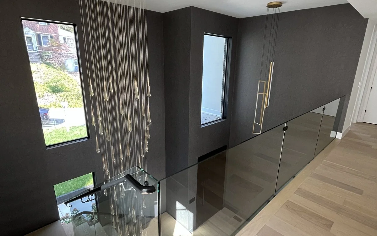 Modern replacement windows bringing daylight into a renovated stair hall